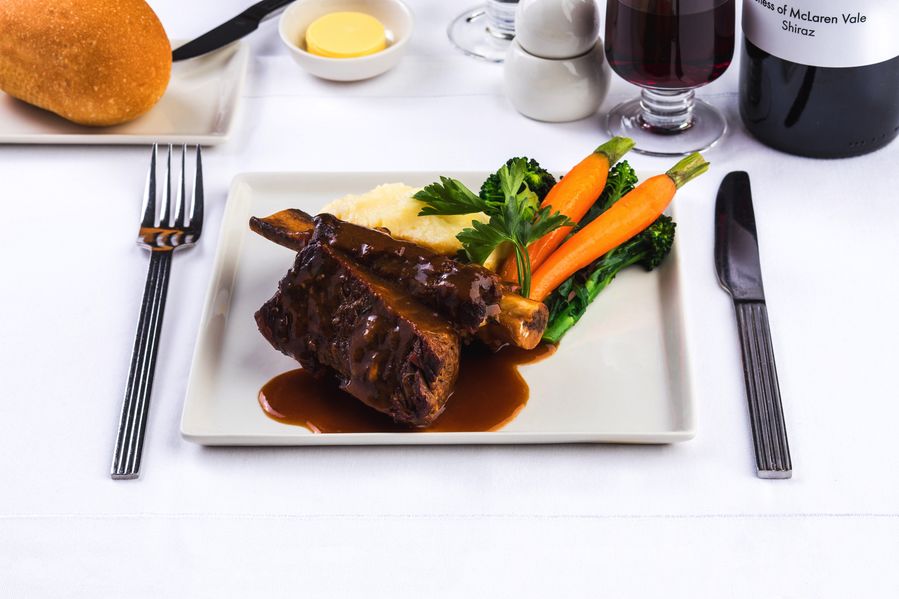 Ale braised beef short rib: Bone in Australian Beef rib, slow cooked in dark ale for six hours, served with buttery potato mash, broccolini and sweet Dutch carrots